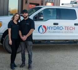 Allyshia Dyck and her husband standing in front of a white truck with the Hydro-Tech logos